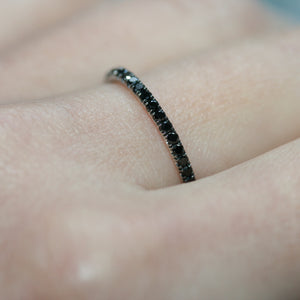 Closeup of a black diamond ring with 18 carat white gold on a lady's hand