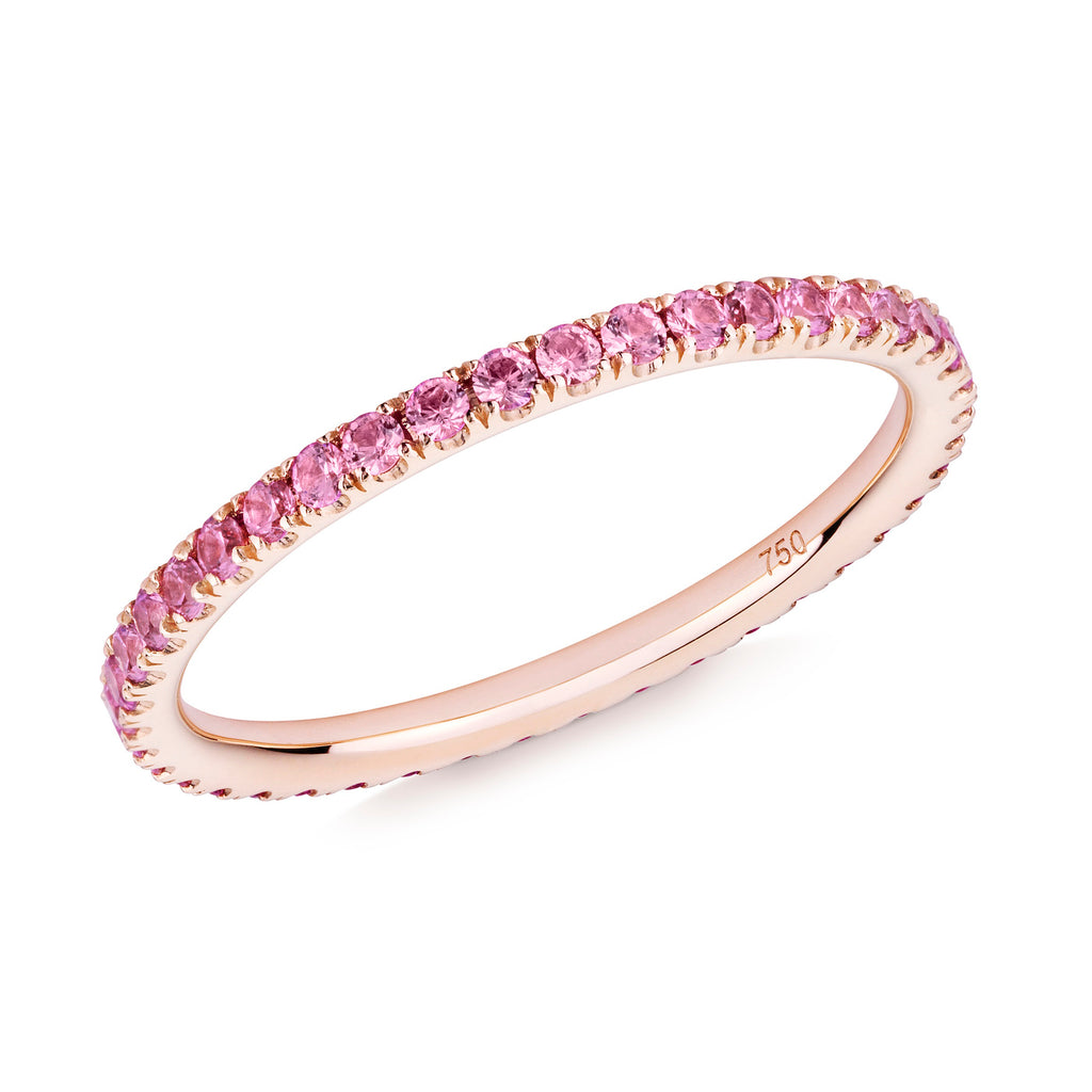 Pink sapphire eternity ring in 18ct rose gold on a white background.