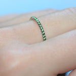 Closer shot of green garnet ring in 18ct white gold on a hand.
