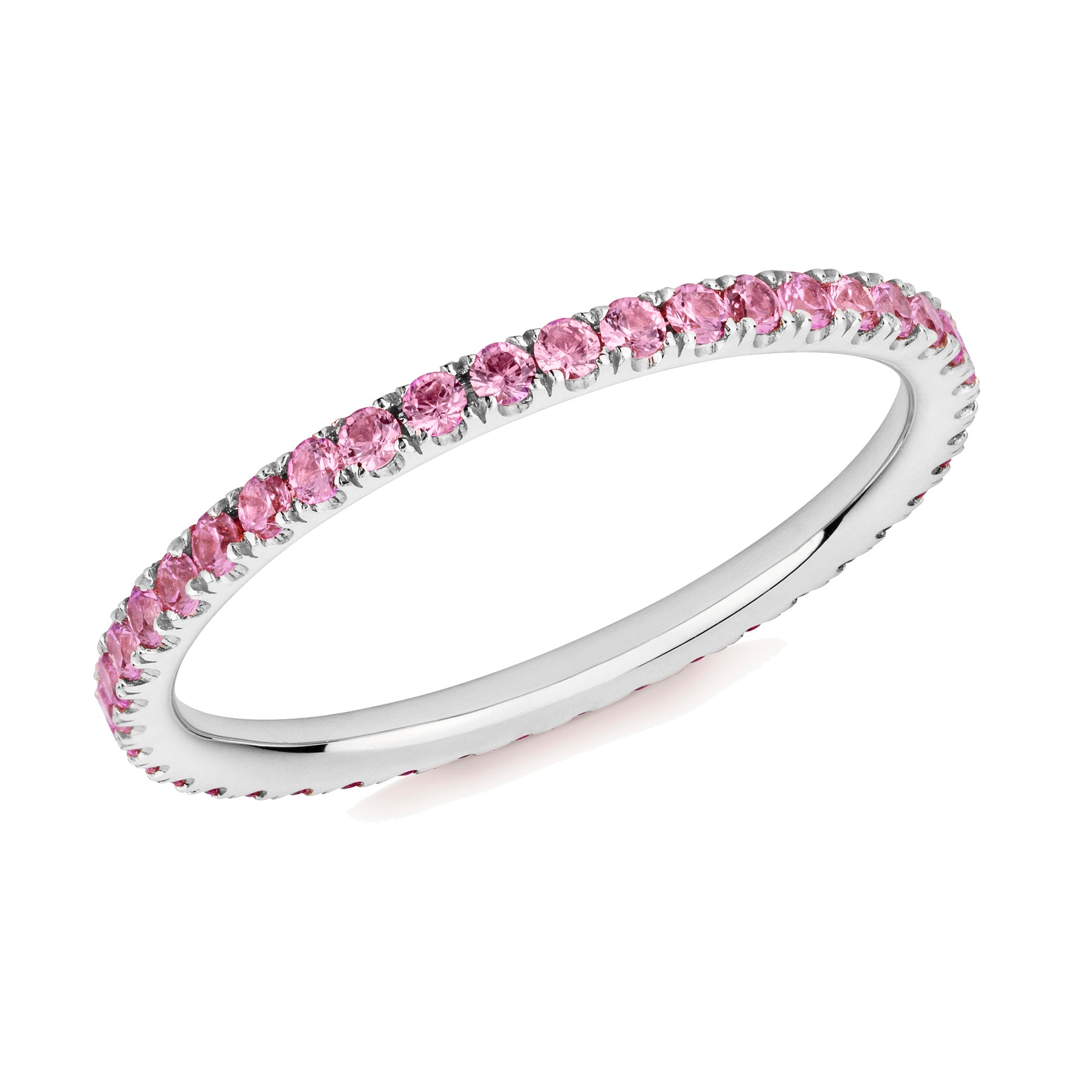 Pink sapphire eternity ring in platinum on a white background.